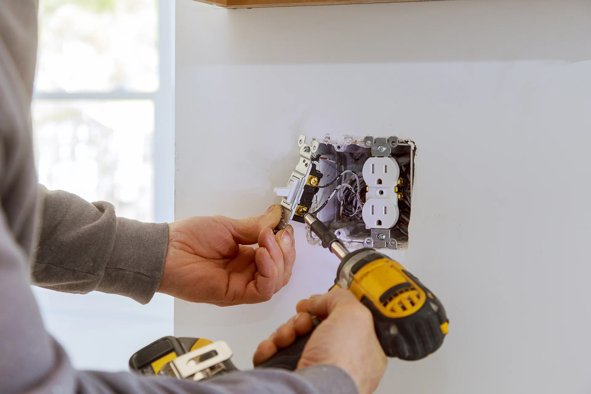 Electrician Installing Wall Light Switch
